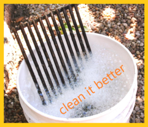 cleaning flat top grill using some hot water in a bucket